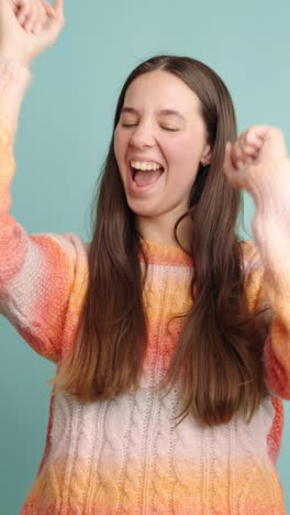 young woman showing different facial expressions on turquoise background