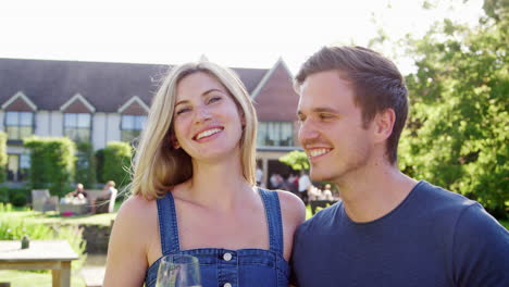 portrait of couple enjoying outdoor summer drink at pub