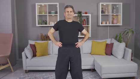 senior old man doing sports at home. doing fitness.