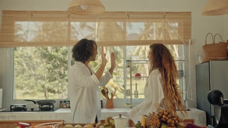 couple dancing in a tropical kitchen