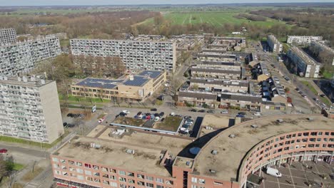 aerial of a large suburban neighborhood with high rise apartment buildings on a sunny day