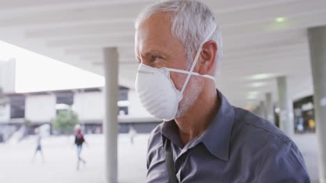 Caucasian-man-out-and-about-in-the-street-wearing-on-a-face-mask-against-coronavirus