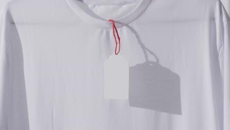 video of white t shirt with tag and copy space on white background