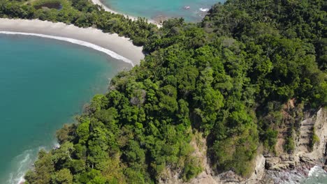 Drone-shot-approaching-Manuel-Antonio-National-Park-small-peninsula,-Costa-Rica