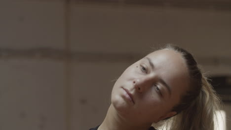 close-up of female sportsman doing circular movements with neck