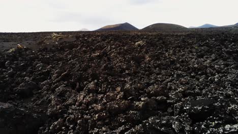 extreme rough volcanic landscape of lanzarote island, low altitude aerial view