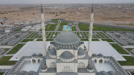 sharjah: aerial drone view of sharjah mosque, the largest mosque in the emirate of sharjah, united arab emirates