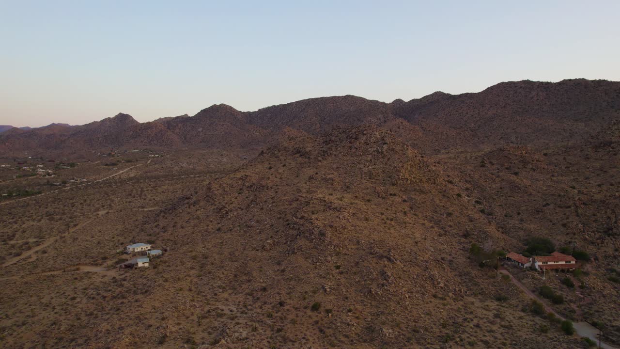 Aerial of Joshua Tree Desert Mountains in Yucca Valley, near National Park at Sunset