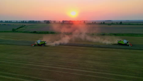 Two-Combine-Harvesters-Trailing-Smoke-in-the-Fields-Aerial