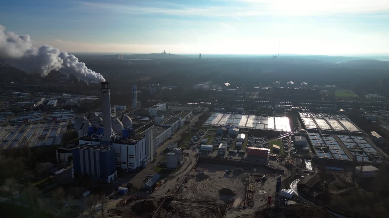 Wastewater treatment plant purifying urban water showing sedimentation tanks, aeration tanks and clarifiers. Marvelous aerial view flight panorama overview drone