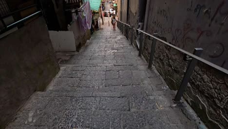 people walking through a narrow alleyway