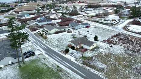 rural neighborhood covered in light layer of snow