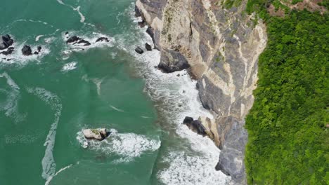 Aerial:-waves-crashing-against-Pacific-Coast-cliffs-in-Mexico