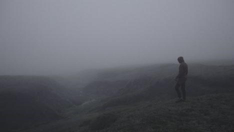 silhouette in abandoned icelandic canyon in a foggy, moody, dramatic landscape