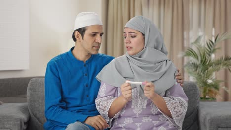 sad muslim couple checking pregnancy test