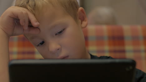 Boy-spending-leisure-time-with-tablet-PC