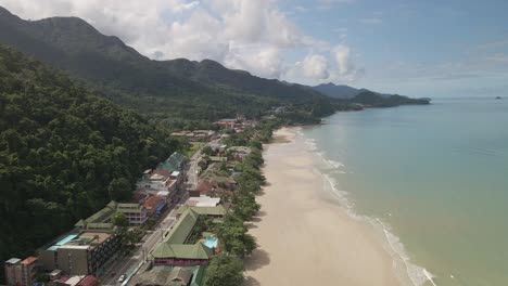 aerial-static-shot-of-Tropical-island-village-with-jungle-beach-resorts-and-ocean