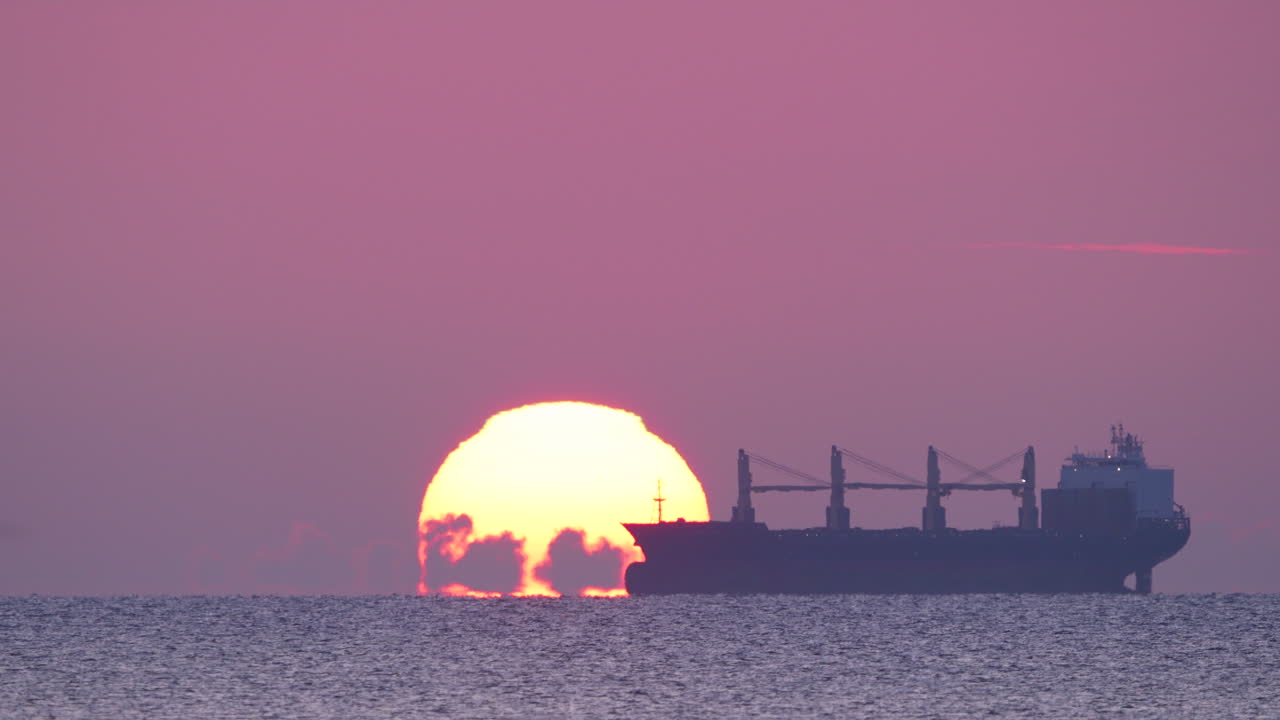 Golden sunrise over Gdynia Orłowo pier with calm sea and serene sky