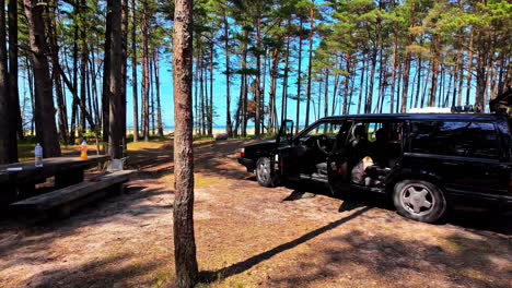 Car-camping-outdoor-bench-in-the-forest,-picnic-location-in-the-woods