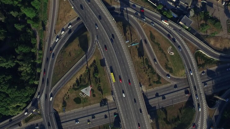 Car driving on freeway overpass. Aerial view car traffic on roundabout highway