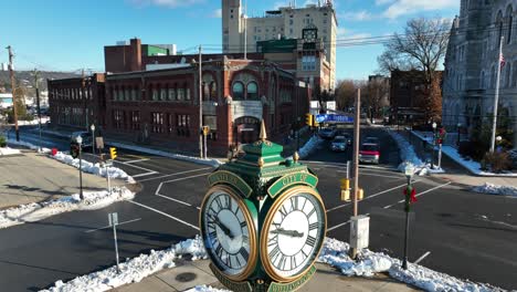 slow aerial rising shot of city of williamsport clock on snowy day in december