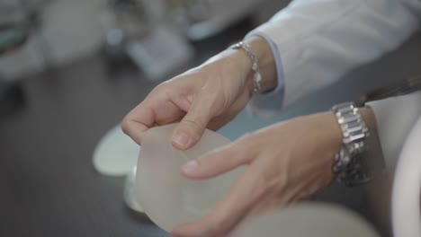 a doctor showing patient silicone breast prosthesis