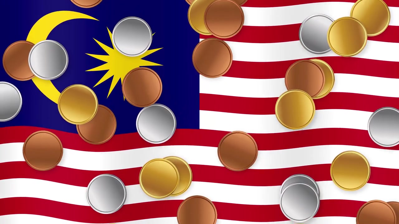 Monete animate d'oro, d'argento e di bronzo che cadono su una bandiera nazionale della Malesia sventolante