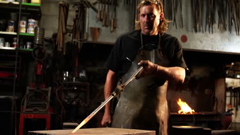 blacksmith working on a iron rod