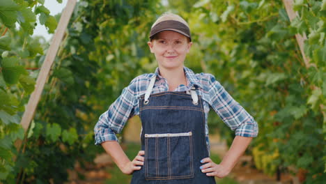 portrait of a farmer woman near a manicured vineyard small business owner