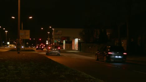 Cars-on-a-busy-road-at-night-time-in-eastern-suburb-in-Berlin,-Germany