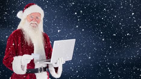 Papá-Noel-Sosteniendo-Una-Computadora-Portátil-Combinada-Con-Nieve-Que-Cae