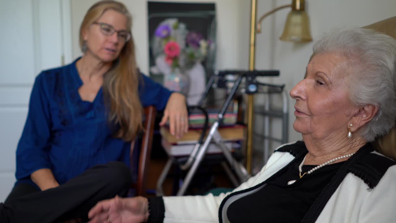 Two women conversing indoors