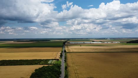 aerial view of small country road between agriculture fields
