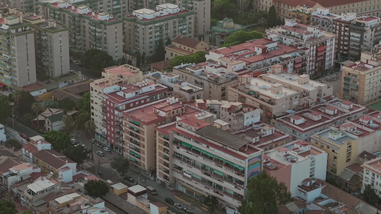 Aerial view of Málaga city, Spain, showcasing residential buildings with red rooftops, urban density, and Mediterranean architecture in the historic Andalusian coastal region