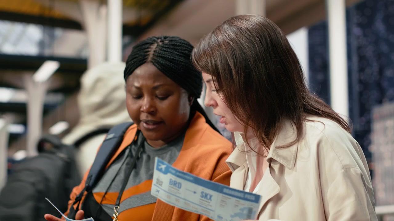 Close up of travel companions reading boarding passes together