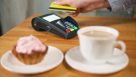 Paying for coffee and pastry with a credit card