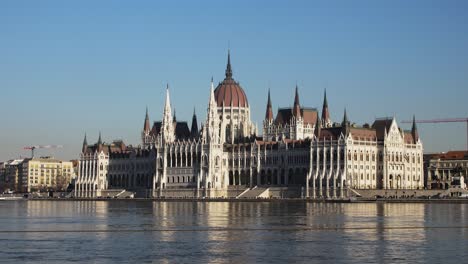 Budapest-city-center-view-with-Parliament-building-and-Danube-river-on-a-sunny-day,-gothic-architecture,-wide-low-angle-panoramic-shot