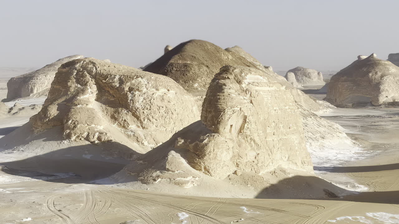 The Egyptian white desert adventure tourism with bedouin camping and 4x4 driving through the desert to see rock formation and sand and dust at sunset and golden hour