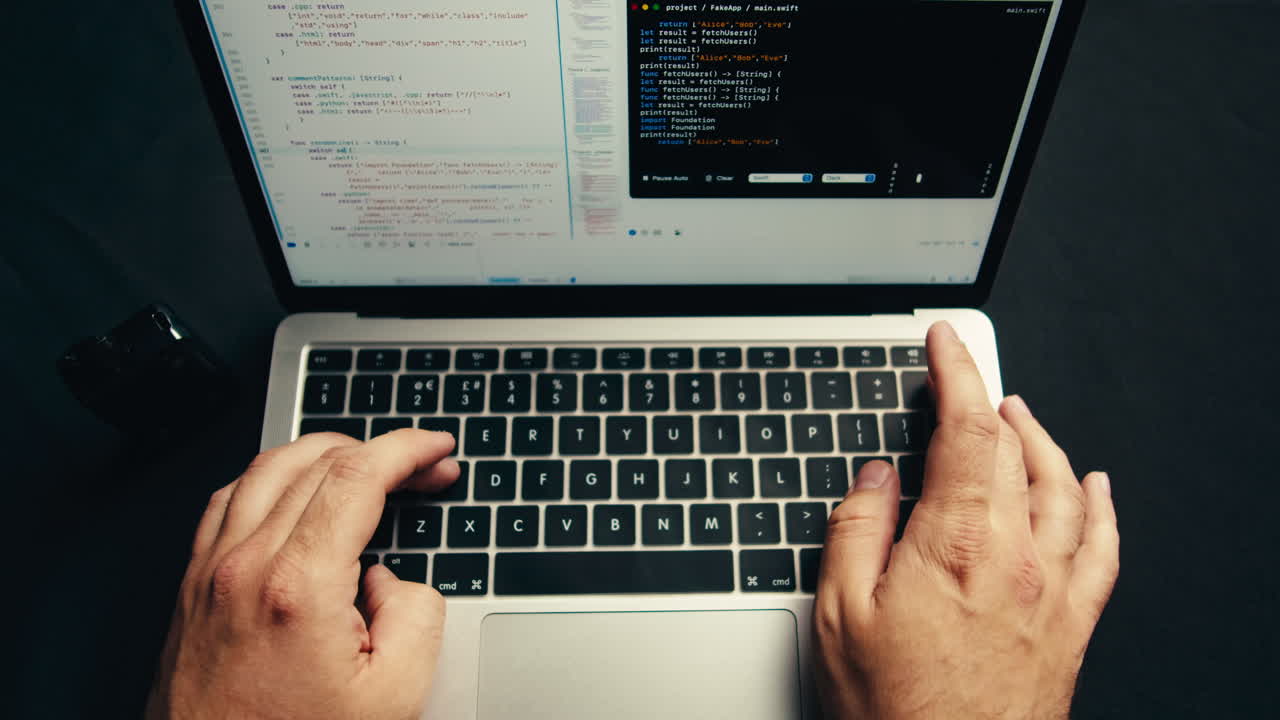 Close-Up of Hands Typing Code on Laptop Keyboard