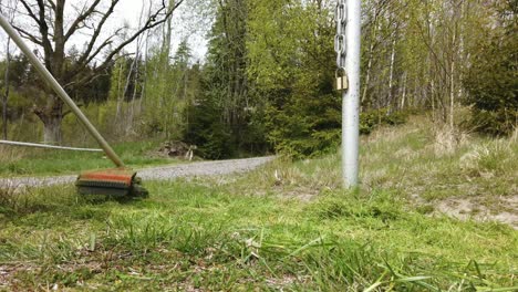 slow motion shot of petrol strimmer spinning, gardener cutting grass