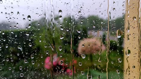 real rain drops sliding on home window glass. heavy rain. close-up of water droplets on glass.