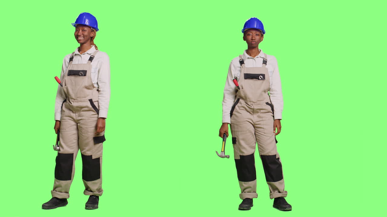 Construction worker with hammer on green screen
