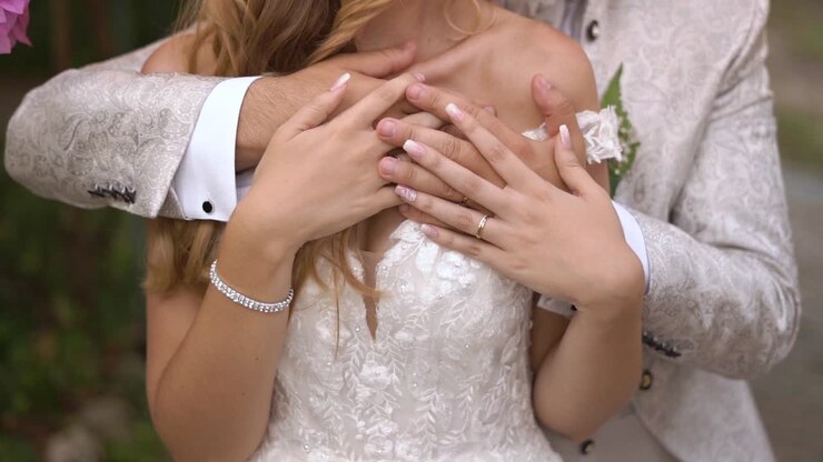 Slow motion shot of Groom and Bride hugging and showing wedding Rings, Camera floating shot