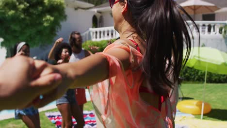 diverse group of friends having fun and dancing at a pool party