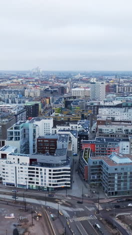 vertical aerial over the jatkasaari cityscape, cloudy day in helsinki, finland