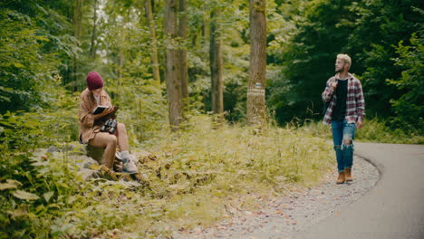 Friends-Exploring-Woods-Amidst-Trees-In-Forest