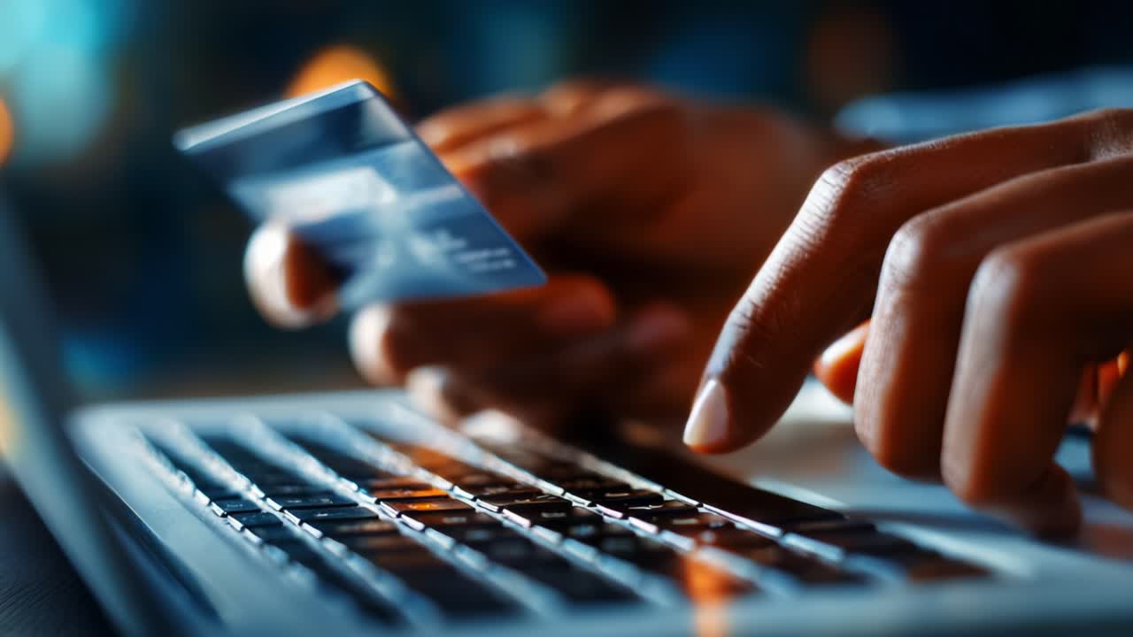 A close-up of hands engaged in online shopping, using a credit card on a laptop keyboard, highlighting the convenience and speed of e-commerce transactions in today's digital age