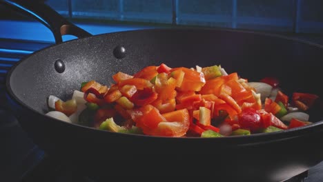 sauteing fresh onions and bell pepper in a pan