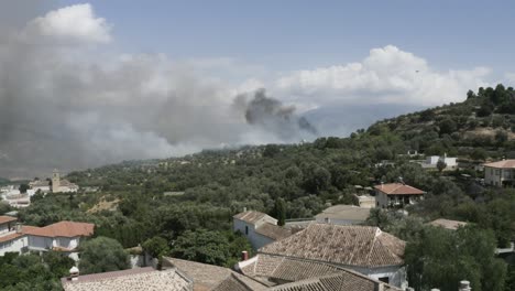 Helicopters-fighting-a-forest-fire-in-Pinos-del-Valle,-Andalucia,-Spain