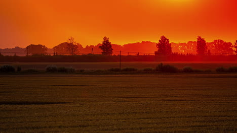 Farbenfroher-Sonnenuntergangshimmel-über-Landwirtschaftlichen-Feldern-Mit-Fleißigem-Ackerschlepper
